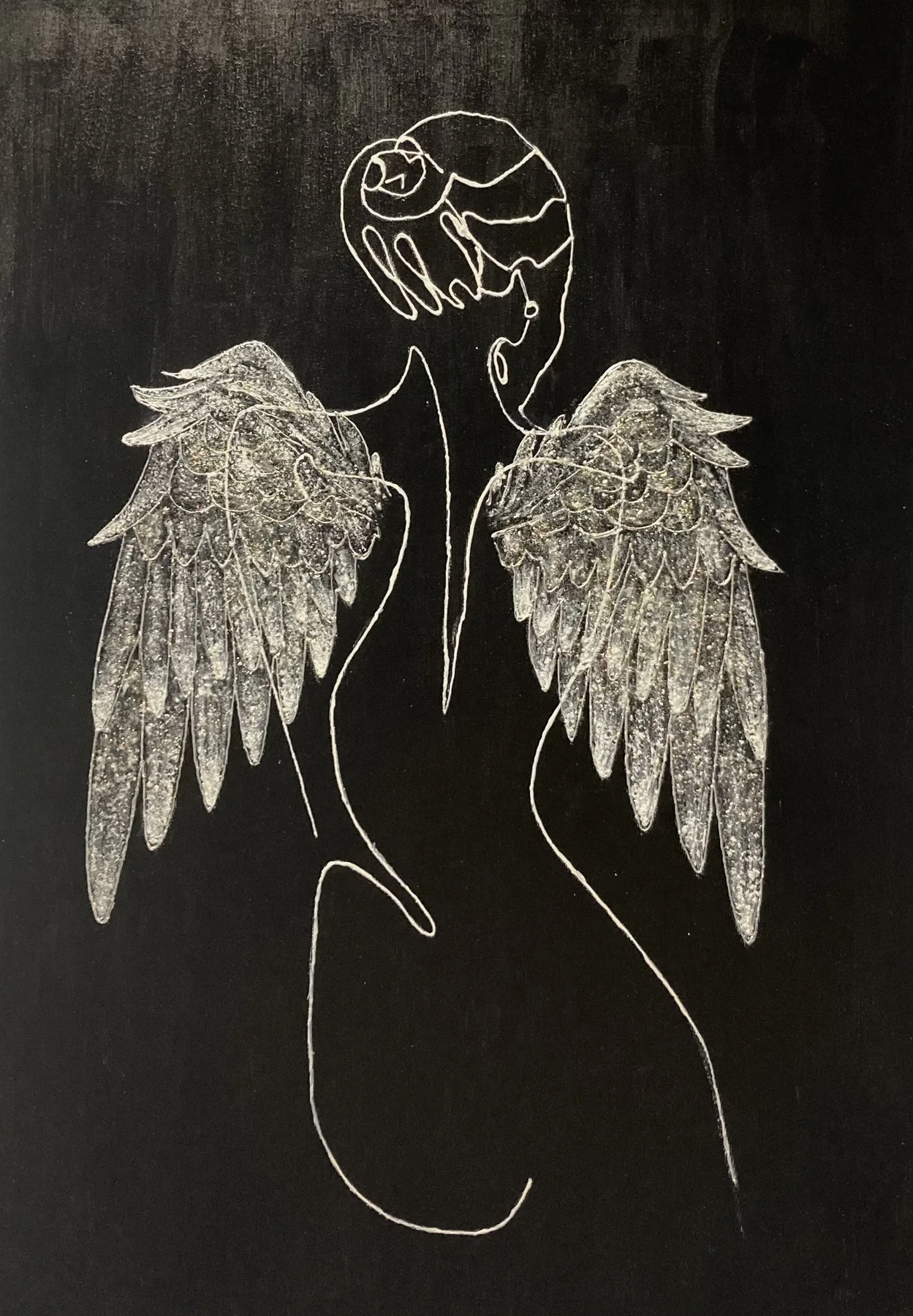 Handmade wing relief against a black background